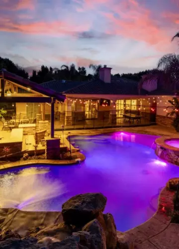 Pool with purple lights and patio area | New Breath Recovery